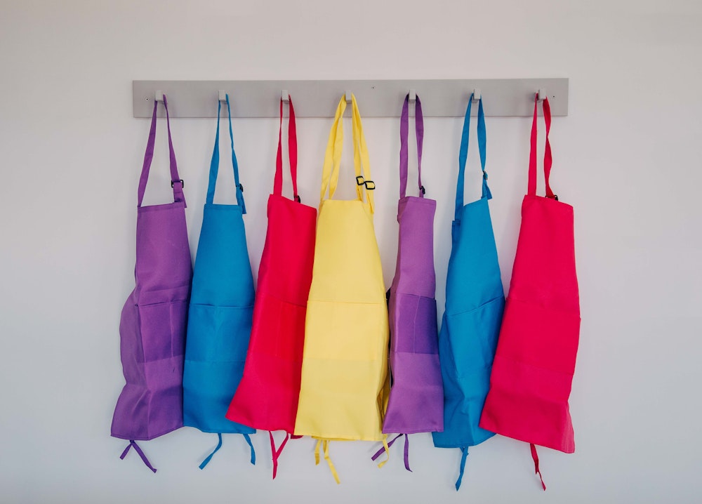 A line of colourful smocks hanging up