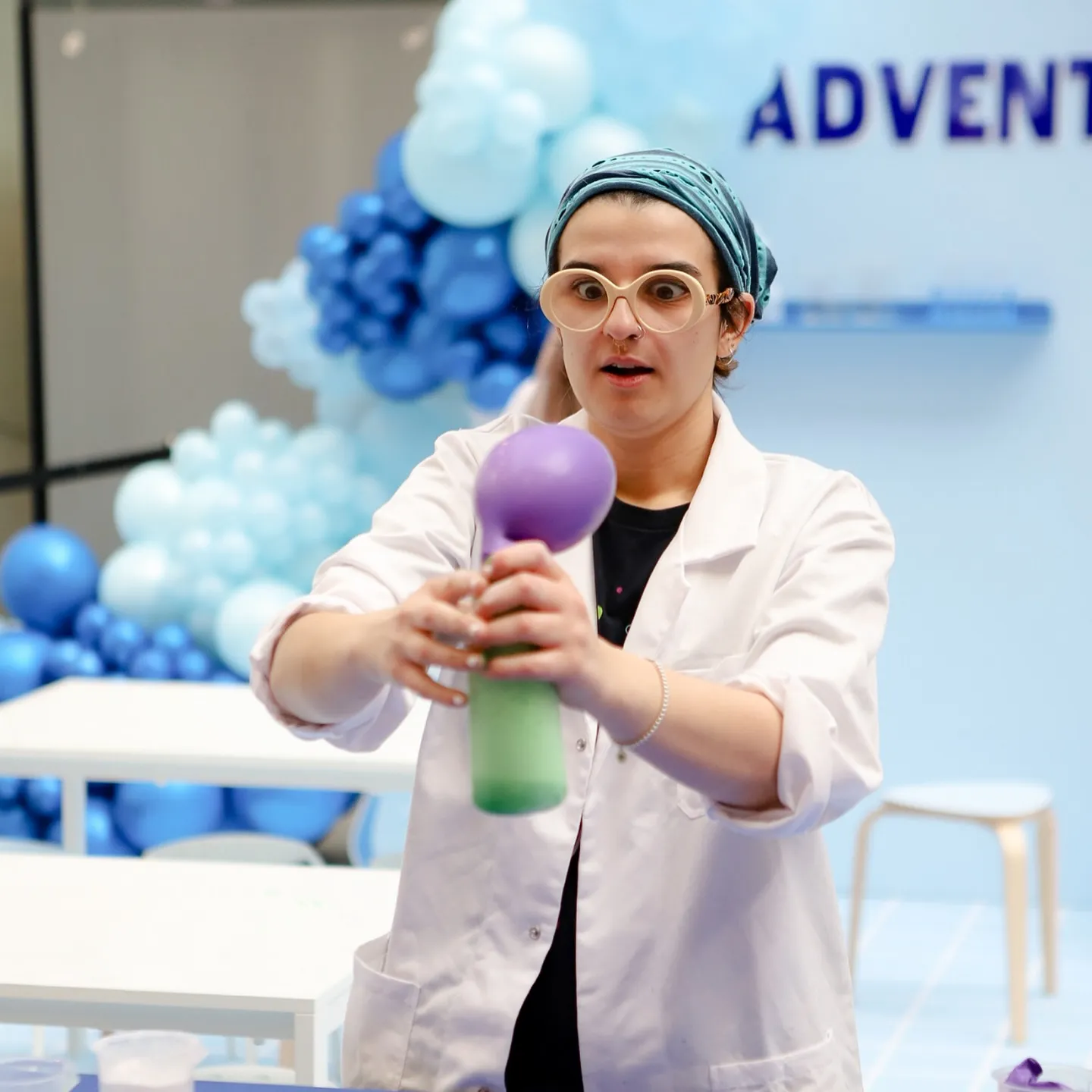 A Fizz Kids staff holding an experiment