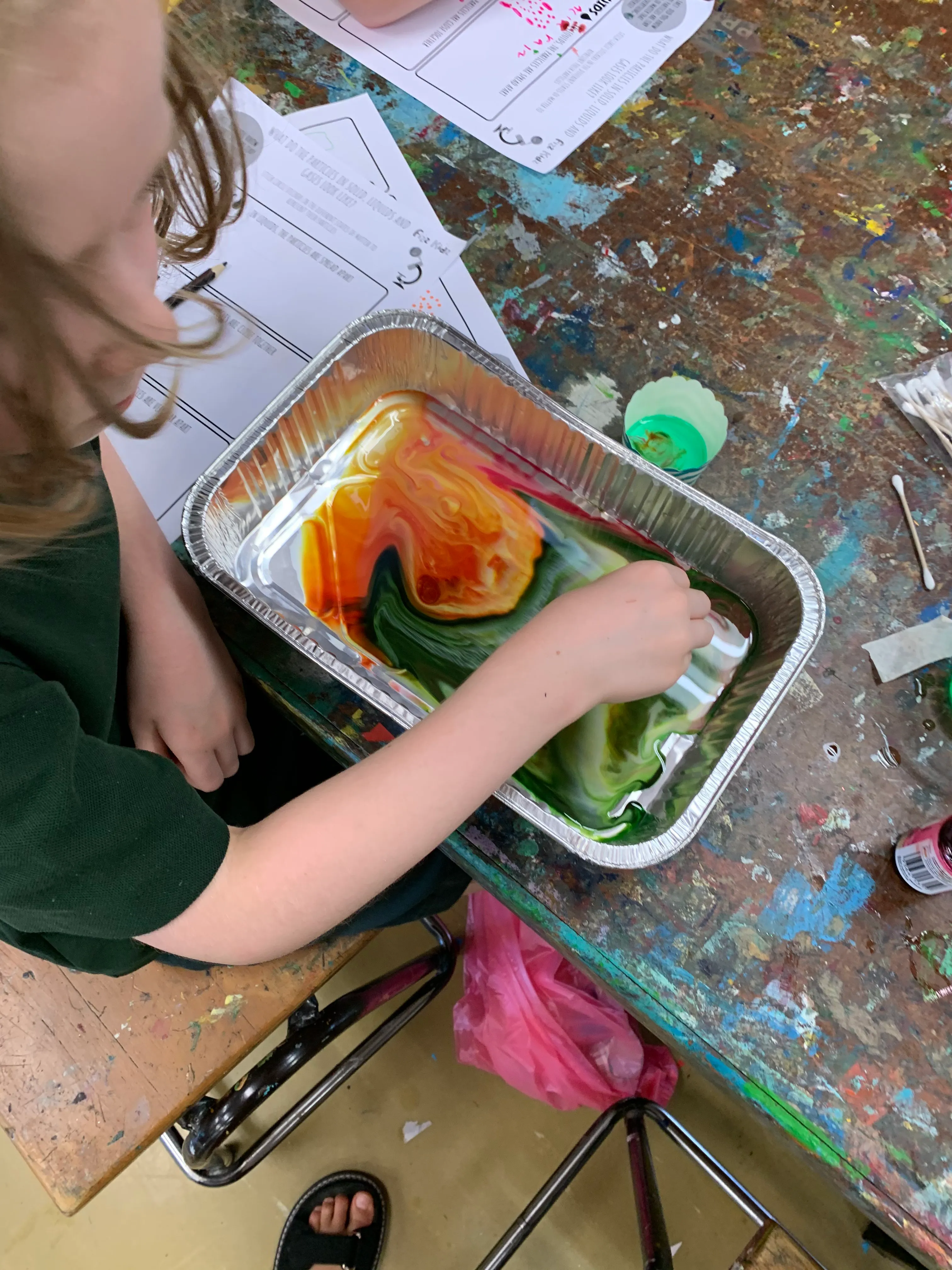 child mixing slime colours