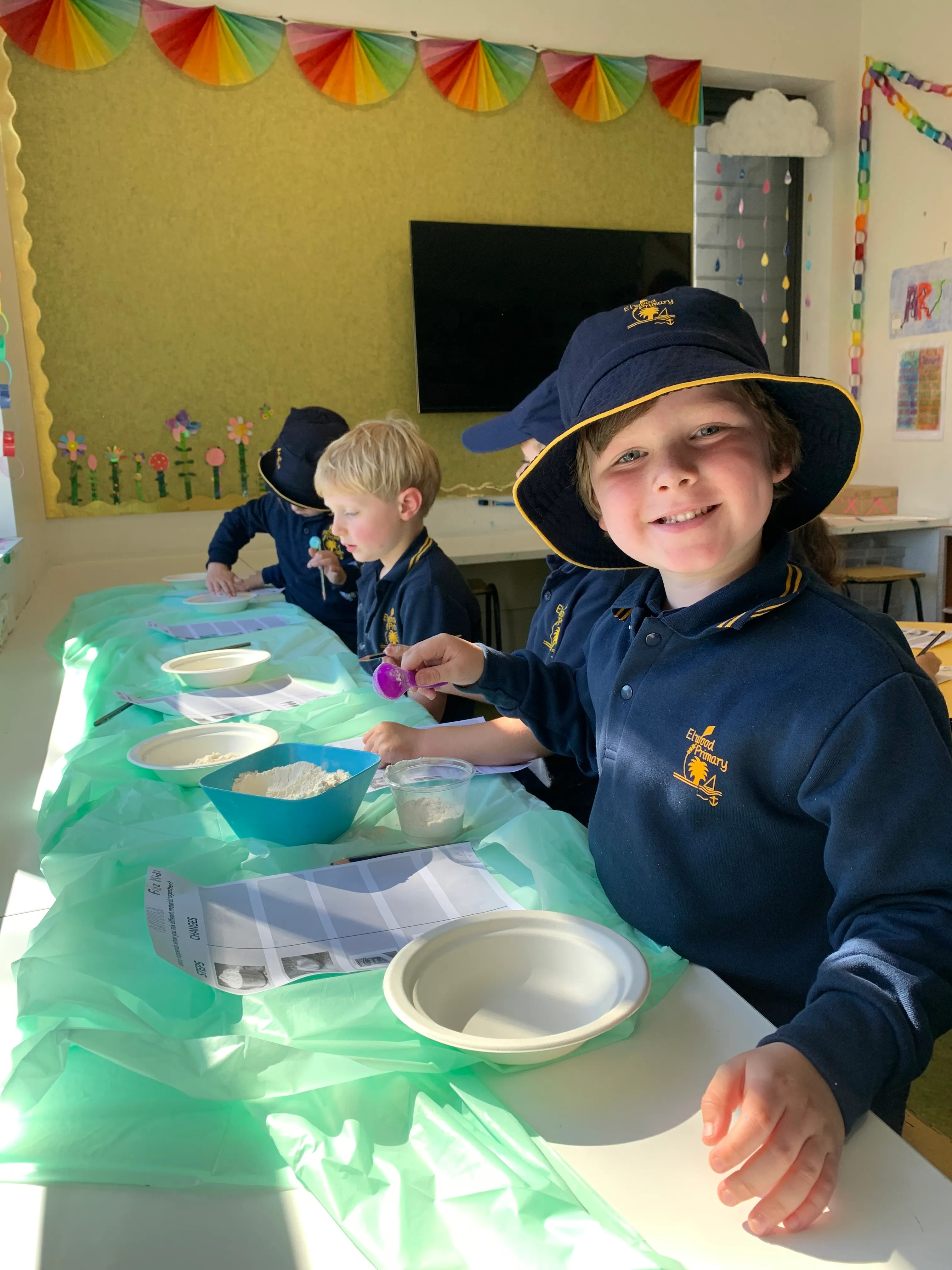 child in a school uniform smiling