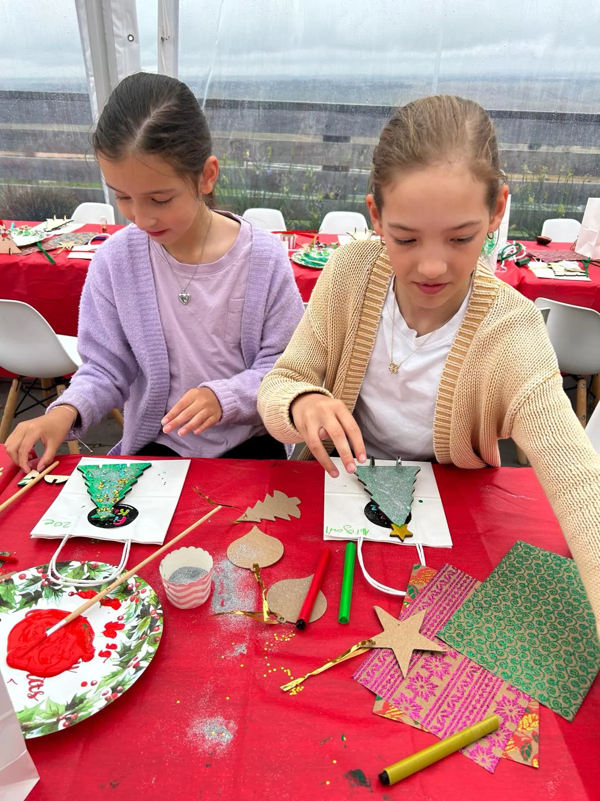 A child making a cutout christmas tree