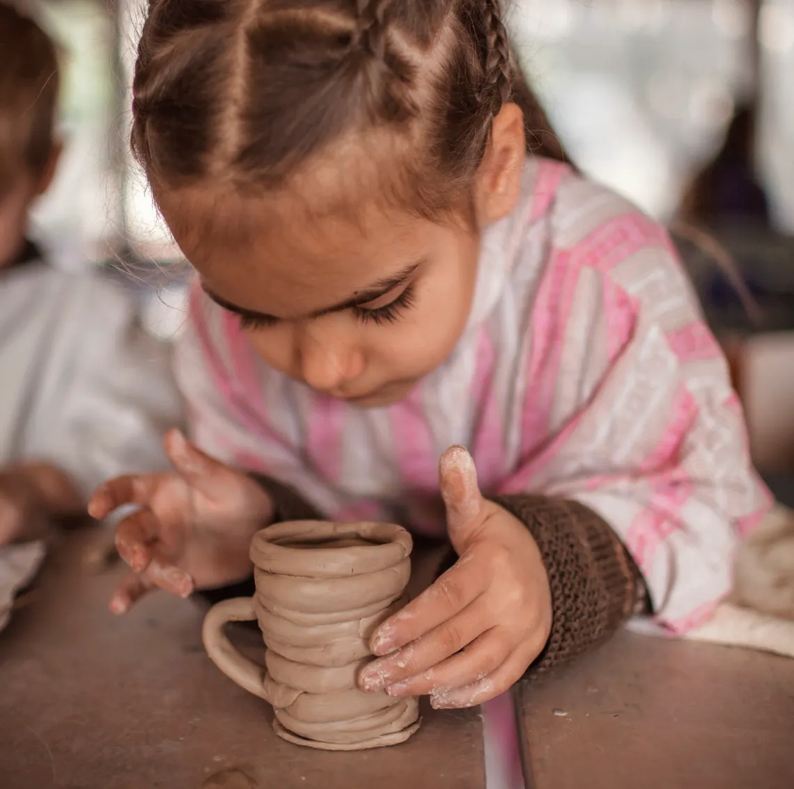 A girl laughing and moulding her experiment