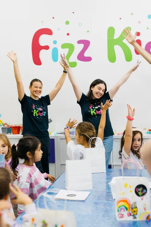 Fizz Kids staff leading a room full of kids