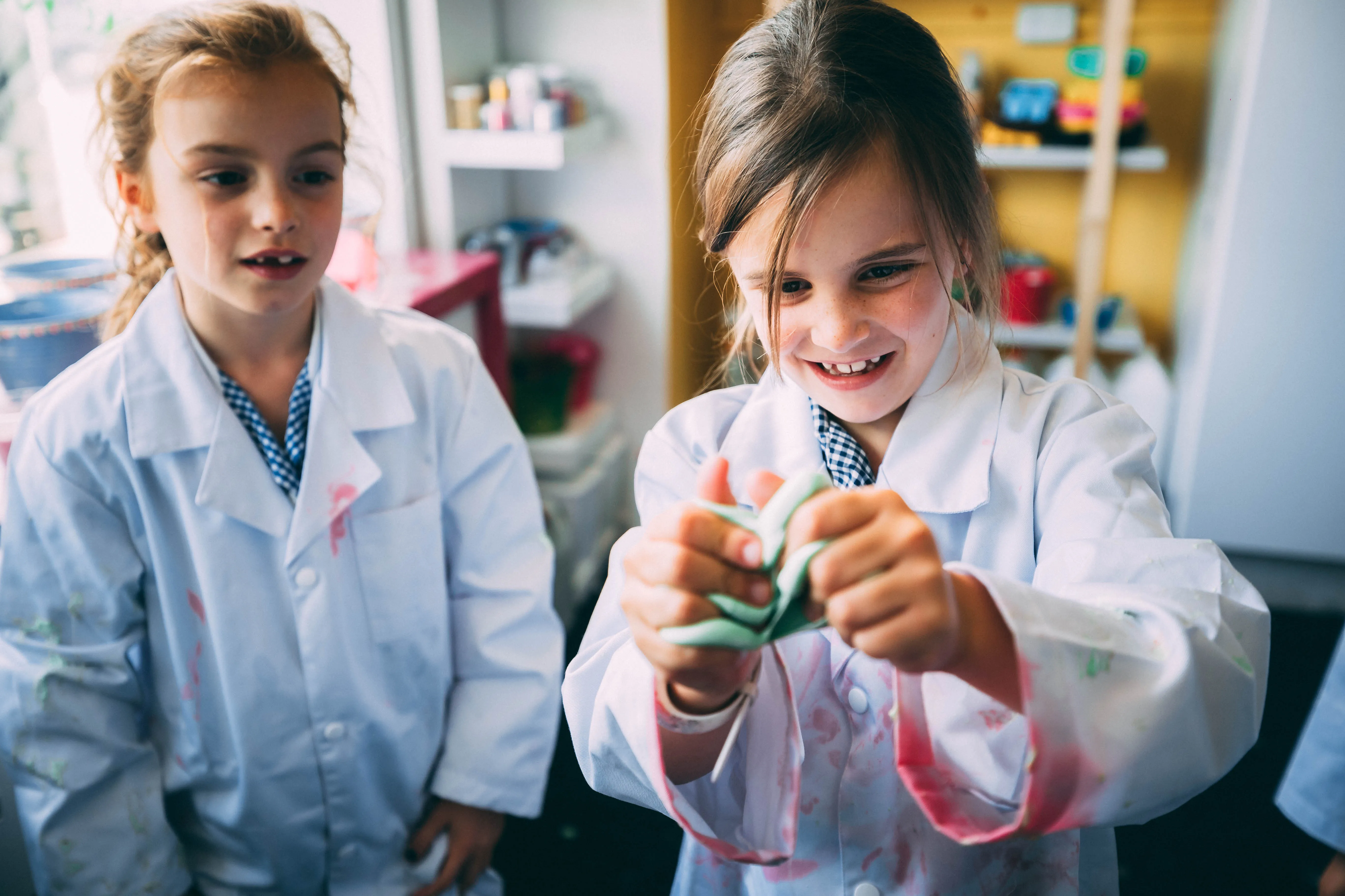 A girl laughing and moulding her experiment