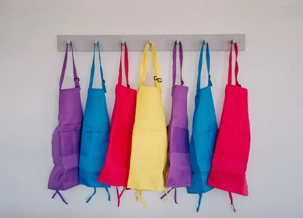 A line of colourful smocks hanging up