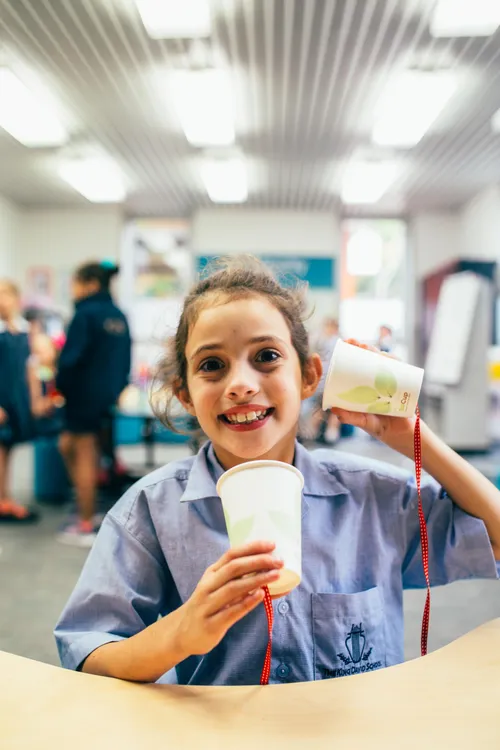 smiling child holding up slime