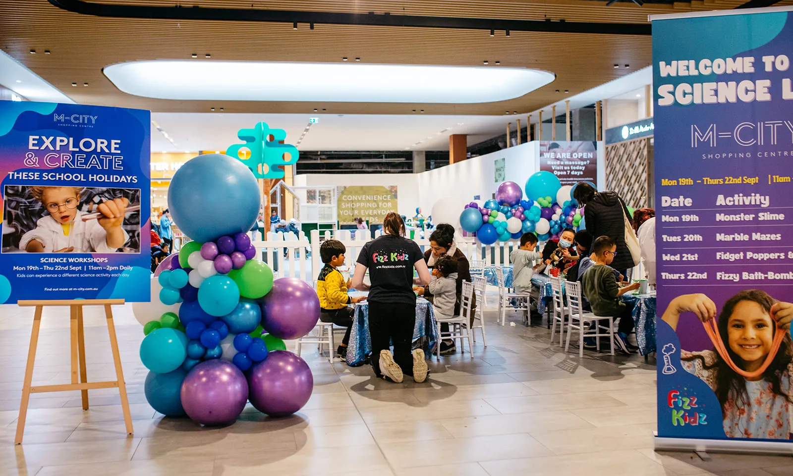 Fiz Kidz running programs for children in a large shopping center with balloons