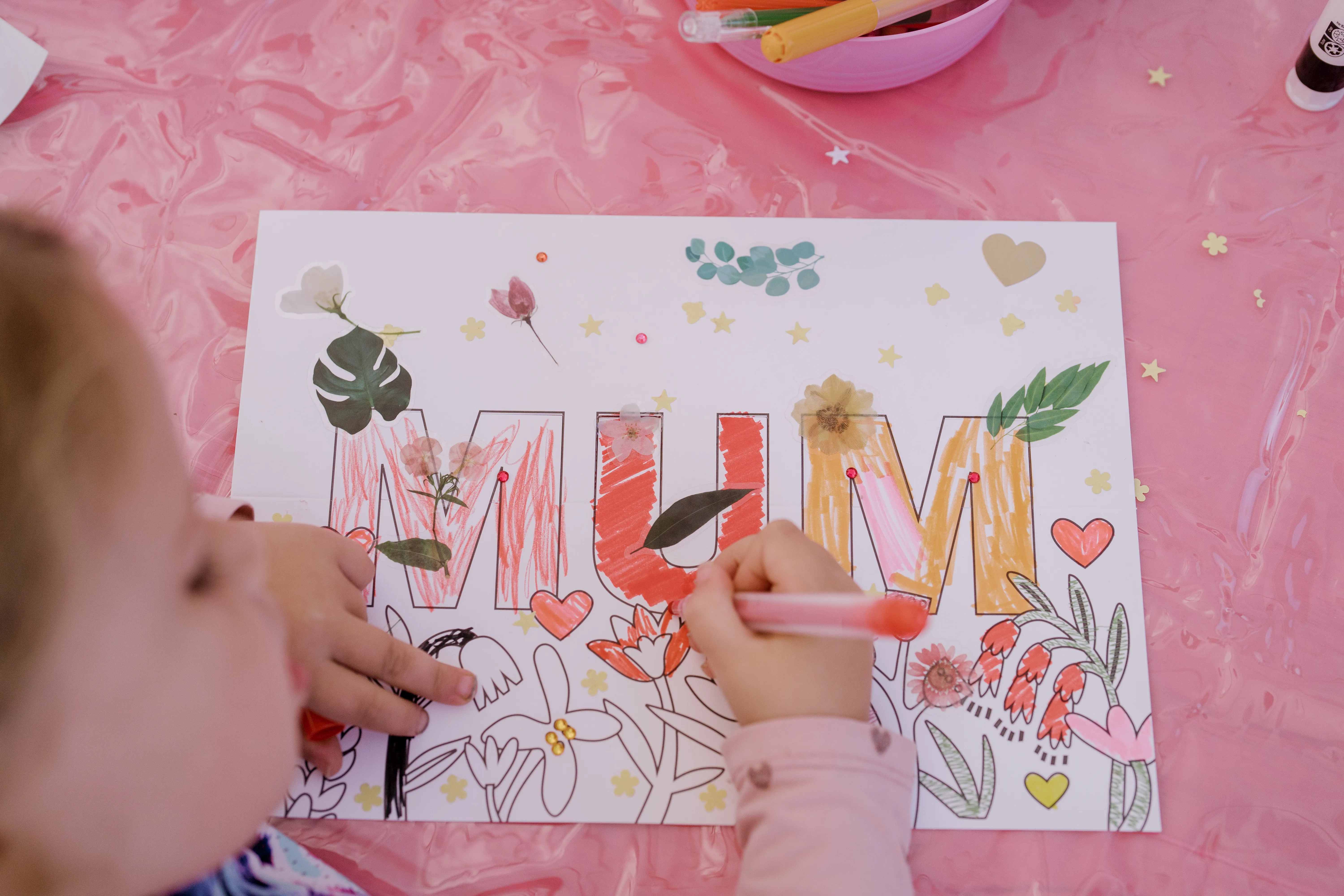 A child colouring in a card for mothers day