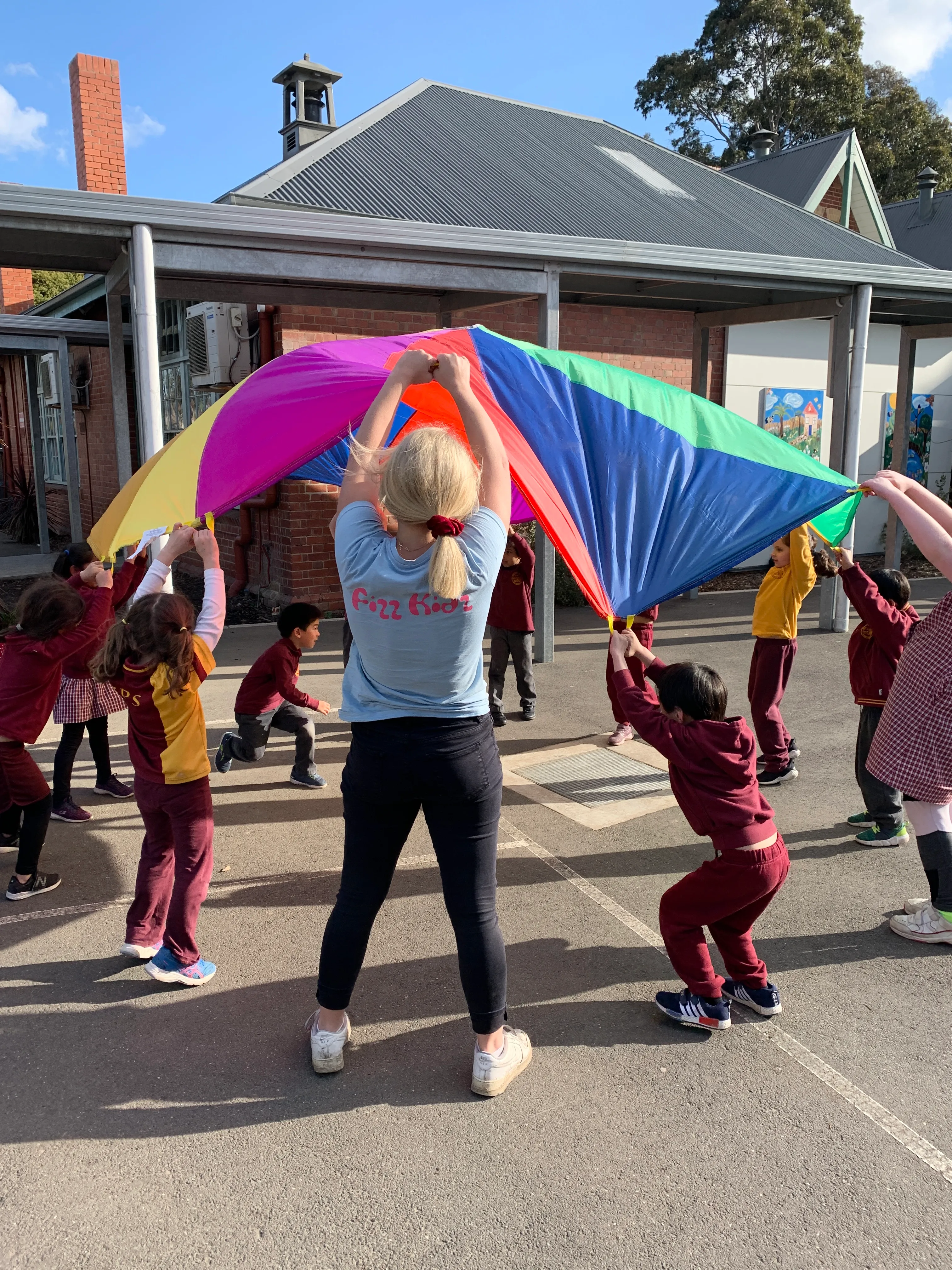 children playing under a parachute