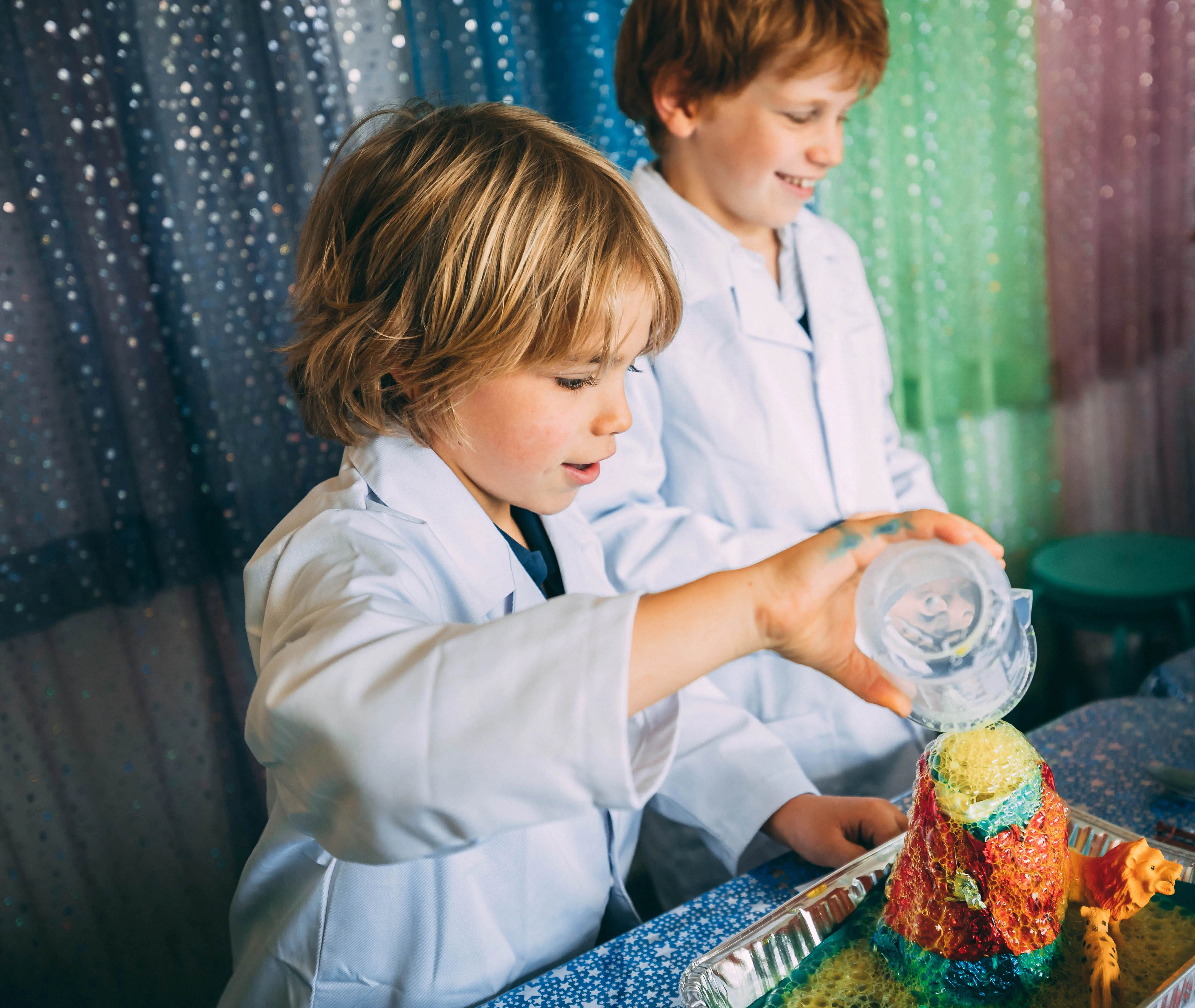 A kid in a lab coat pouring something