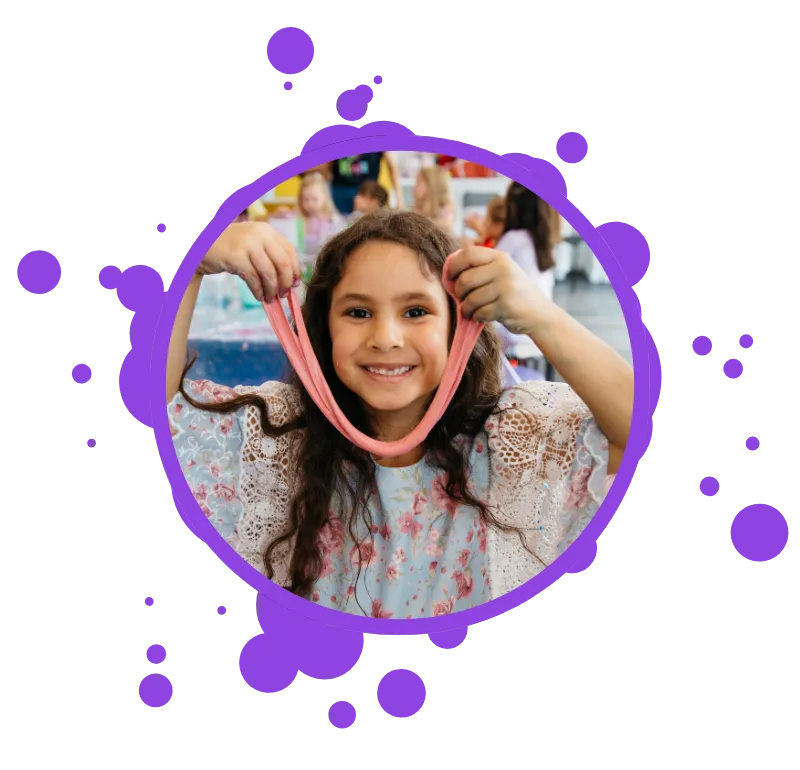 girl holding slime and smiling