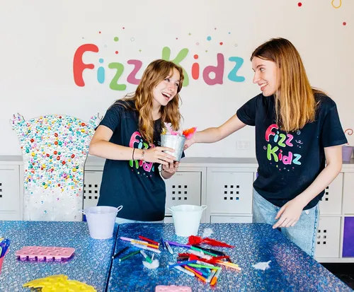 Two Fizz Kids staff working together and smiling