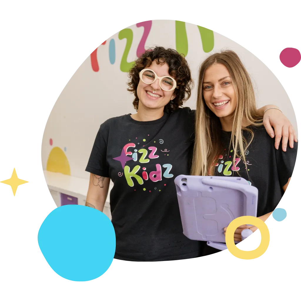 Two Fizz Kids staff smiling with an iPad